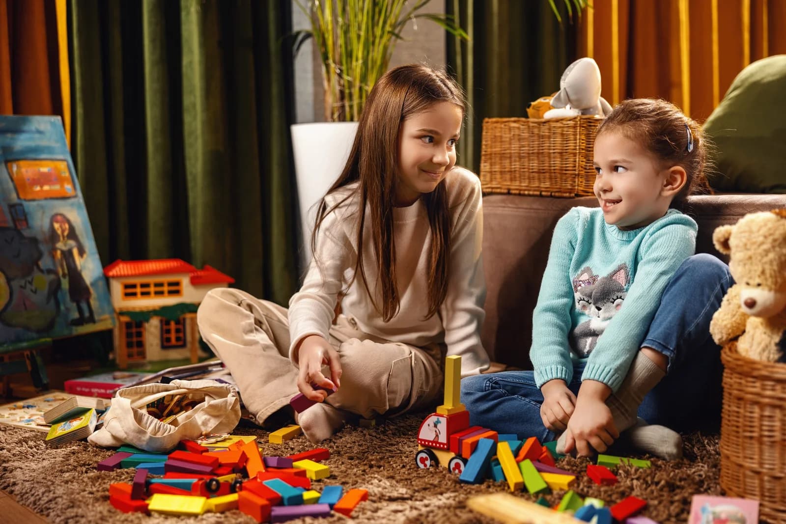 Kids playing with wooden blocks on the floor